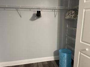 a walk in closet with a blue trash can at Cheerful 3-bedrooms with free parking on premises in Tallahassee