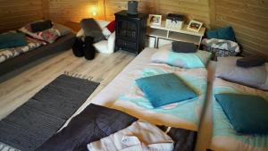 a room with three beds and a stove at Fińska Wioska Kalevala in Borowice