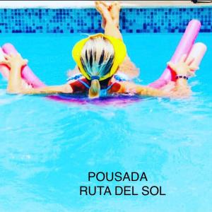 莫索羅的住宿－Ruta Del Sol，小孩躺在游泳池的木筏上