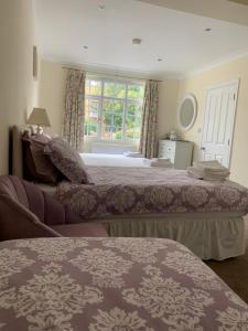 a bedroom with two beds and a window at Leverton House in Cambridge