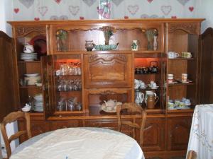 a wooden hutch with cups and dishes in it at Dolce-Nido in Mougins