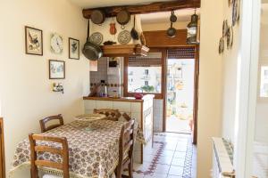 a kitchen with a table and some pots and pans at Capitano Nino Guest House in Meta
