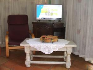 a table with two baskets on it with a television at Dolce-Nido in Mougins