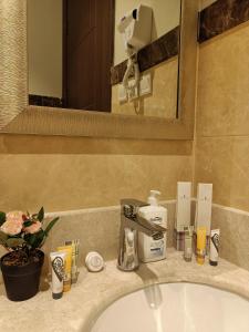 a bathroom counter with a sink and a mirror at F residence, Beauty & Luxury in Riyadh