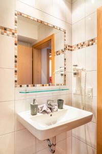 a bathroom with a sink and a mirror at Öko-Appartements Fallhaus in Forstau +41 photos