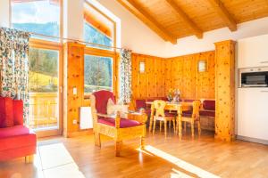 a kitchen and dining room with a table and chairs at Öko-Appartements Fallhaus in Forstau
