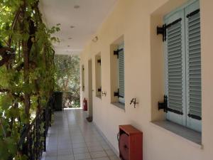 a hallway of a house with windows and a tile floor at Katerina Apartments in Tsoukaladhes