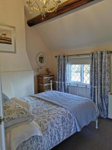 a bedroom with a bed and a window at The Casey in Fenny Bentley