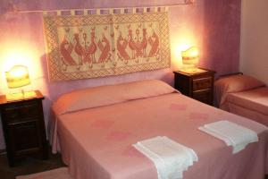 Postel nebo postele na pokoji v ubytování Agriturismo nuraghe Putzu Canu