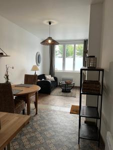 a living room with a couch and a table at LES GRENOUILLES in Amiens
