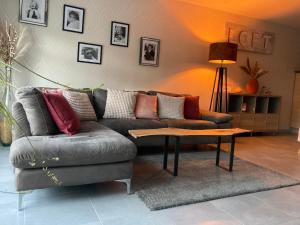 a living room with a couch and a coffee table at PROGÎTES "Le Loft" in Quiévrain