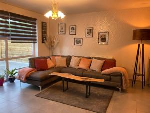 a living room with a couch and a table at Le Loft in Quiévrain