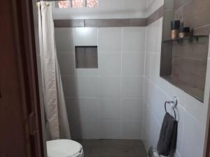 y baño con aseo y ducha. en Villa Paraiso en Emiliano Zapata