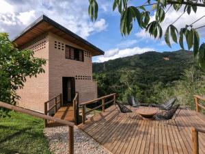 une maison dotée d'une terrasse en bois avec une table et des chaises dans l'établissement Palagua Lodge, à San Rafael