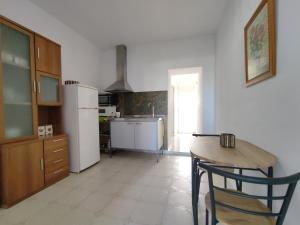 a kitchen with a table and a refrigerator at PISO PLAYA ALCOSSEBRE in Alcossebre
