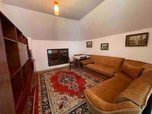 a living room with a couch and a rug at Vilă in Izbuc, Bihor - Casa Moma in Cărpinet