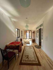 a bedroom with a bed and a table and a chair at Vilă in Izbuc, Bihor - Casa Moma in Cărpinet
