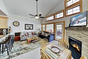 a living room with a fireplace and a tv at La Riva Del Lago 209 in Dillon