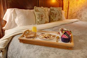 a tray of food on top of a bed at Margaretville Mountain Inn B&B in Margaretville +26 photos