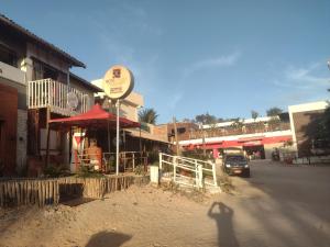 a shadow of a person standing on the side of a street at Casa Jeri in Jericoacoara