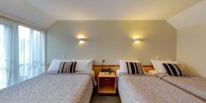 Postel nebo postele na pokoji v ubytování Dunedin Leisure Lodge - Distinction
