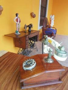 a room with a wooden table with a telephone and a desk at Hacienda Valentina in Playa del Carmen