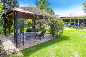 a gazebo with a table and chairs in a yard at Downtown Suites in Boquete