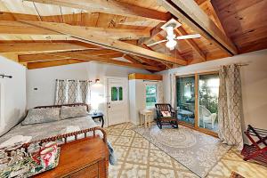 a bedroom with a bed and a wooden ceiling at Atlantic Gardens in Boothbay Harbor