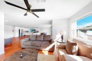 a living room with a couch and a ceiling fan at Manassas Place in Tucson