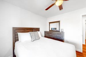 a bedroom with a white bed and a ceiling fan at Manassas Place in Tucson +21 photos