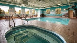 a large swimming pool in a hotel room with a pool at Best Western Plus Osoyoos Hotel & Suites in Osoyoos