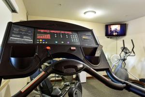 a room with a gym with a machine and a television at Best Western Plus Osoyoos Hotel & Suites in Osoyoos