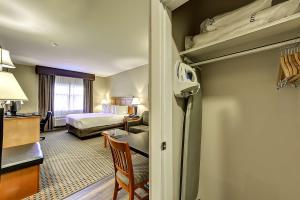 a hotel room with a bedroom with a bed at Best Western Plus Osoyoos Hotel & Suites in Osoyoos