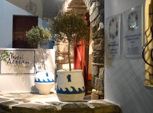 two blue and white vases with trees in them at Aegean Village in Parikia