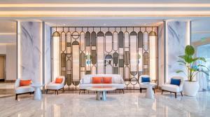 a rendering of a hotel lobby with a bed and chairs at Radisson Blu Hotel & Resort, Abu Dhabi Corniche in Abu Dhabi +37 photos