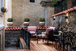 a patio with chairs and tables on a building at Art Boutique Hotel Gallery 37 Plovdiv - Superb Location in the Old Town in Plovdiv