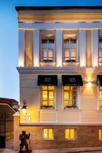 a man with a camera standing in front of a building at Gallery 37 Powered by ASTON in Plovdiv