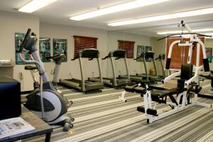a gym with several treadmills and exercise bikes at Sonesta Simply Suites Fort Worth in Fort Worth