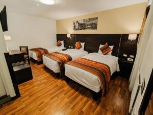 Ένα ή περισσότερα κρεβάτια σε δωμάτιο στο Royal Inn Cusco Hotel