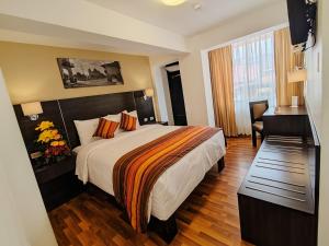 Ένα ή περισσότερα κρεβάτια σε δωμάτιο στο Royal Inn Cusco Hotel