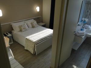 Postel nebo postele na pokoji v ubytování Hotel Moderno