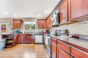 a large kitchen with wooden cabinets and stainless steel appliances at I Spy The Enchantments in East Wenatchee