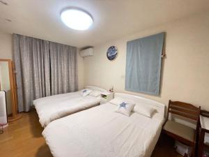 Postel nebo postele na pokoji v ubytování MIKOTO HOUSE