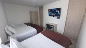 Voodi või voodid majutusasutuse Bayit Tov Circunvalar Hotel toas