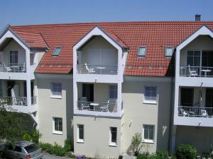 a row of apartment buildings with red roofs at Appartementhaus Zum Fuchswirt in Bad Füssing