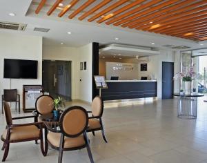 a lobby with a waiting area with chairs and a table at Sancrest Residence Deltamas in Cikarang