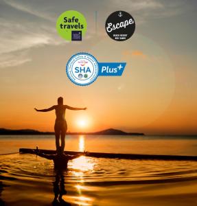 uma pessoa de pé na praia com o pôr-do-sol ao fundo em Escape Beach Resort - SHA Extra Plus Certified em Mae Nam