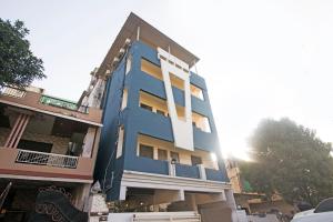 a blue building with the sun behind it at Octave Taj Palace in Nagpur