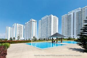 a swimming pool in front of some tall buildings at SMDC Tagaytay Taal Lake View Condo Netflix No Balcony Contact to Confirm in Tagaytay