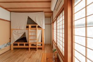 Postel nebo postele na pokoji v ubytování Guest House Takazuri-KITA